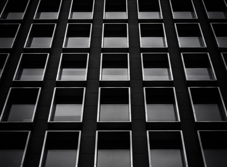 Black and white photograph of a repeating window pattern on an office building in London