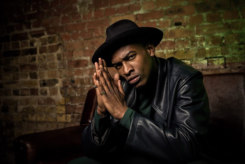 Fashion photograph, one man in hat and leather jacket