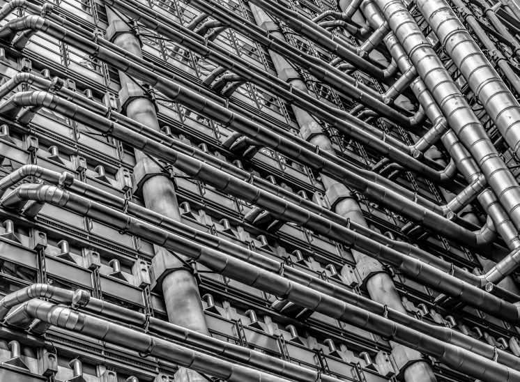 Maze of exterior pipework in black and white