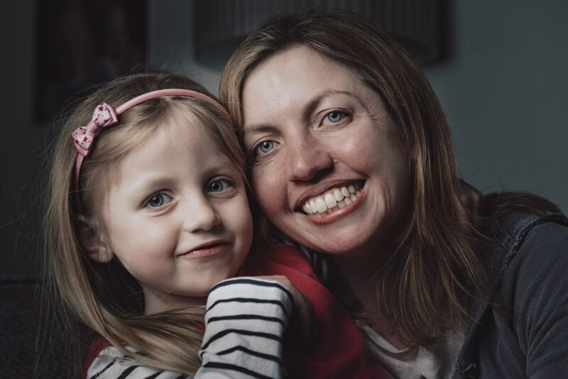 Cute picture of woman and girl smiling to camera